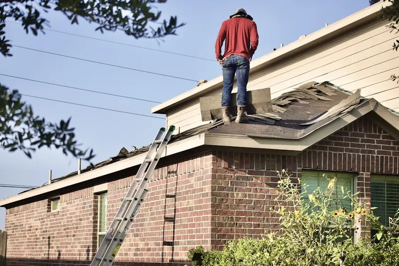 Professional roofer working on a residential roof in Locke